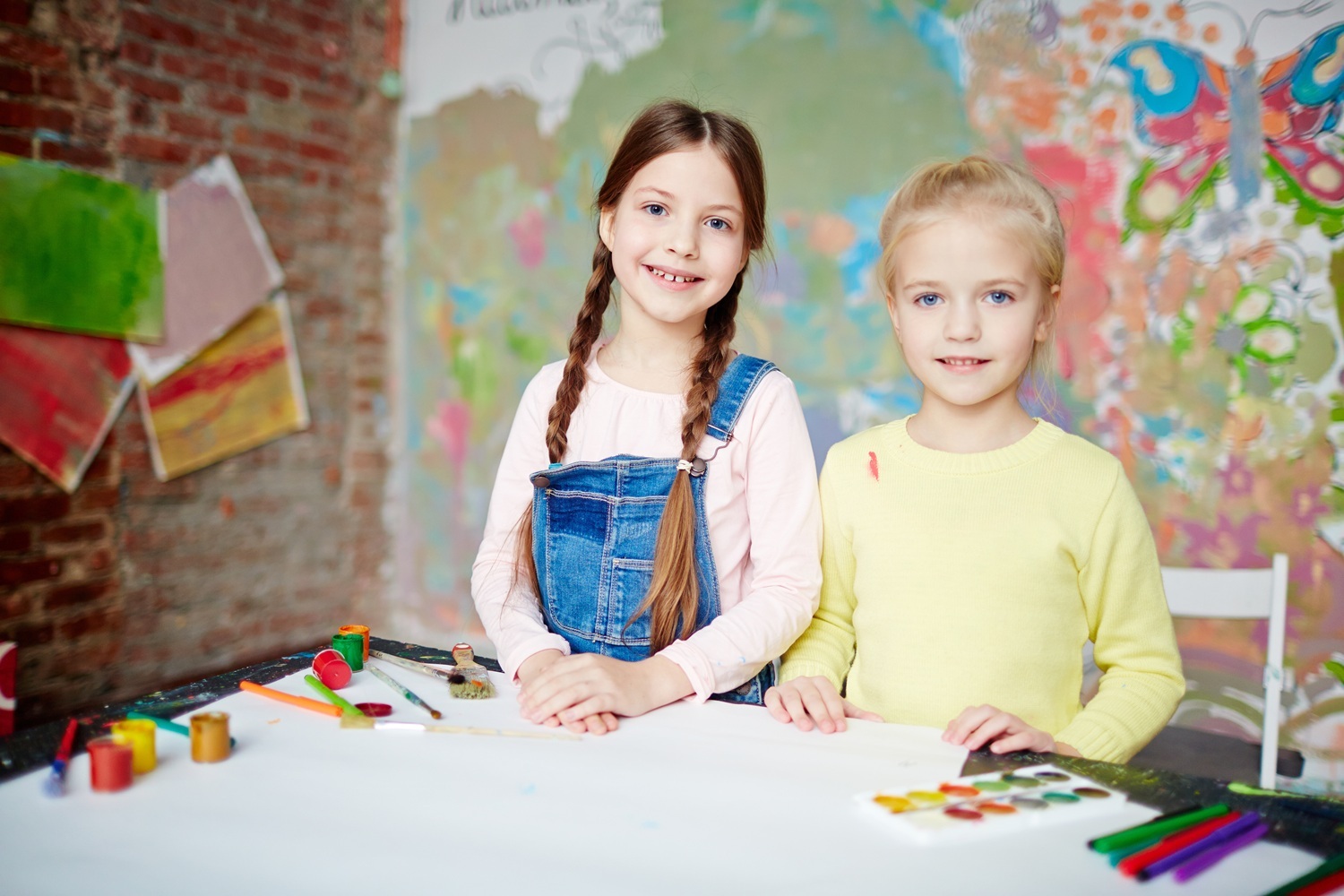 Two creative little girls looking at camera